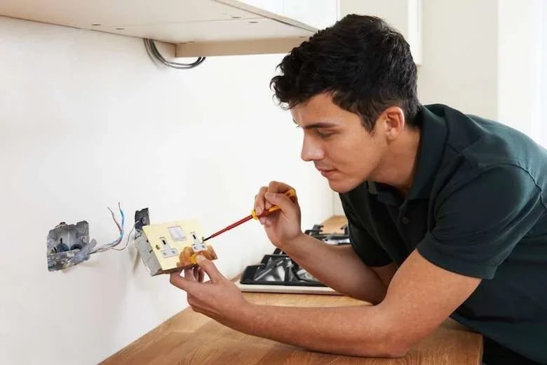 Romford electrician installing a new socket in a kitchen — domestic electrical services in Gidea Park